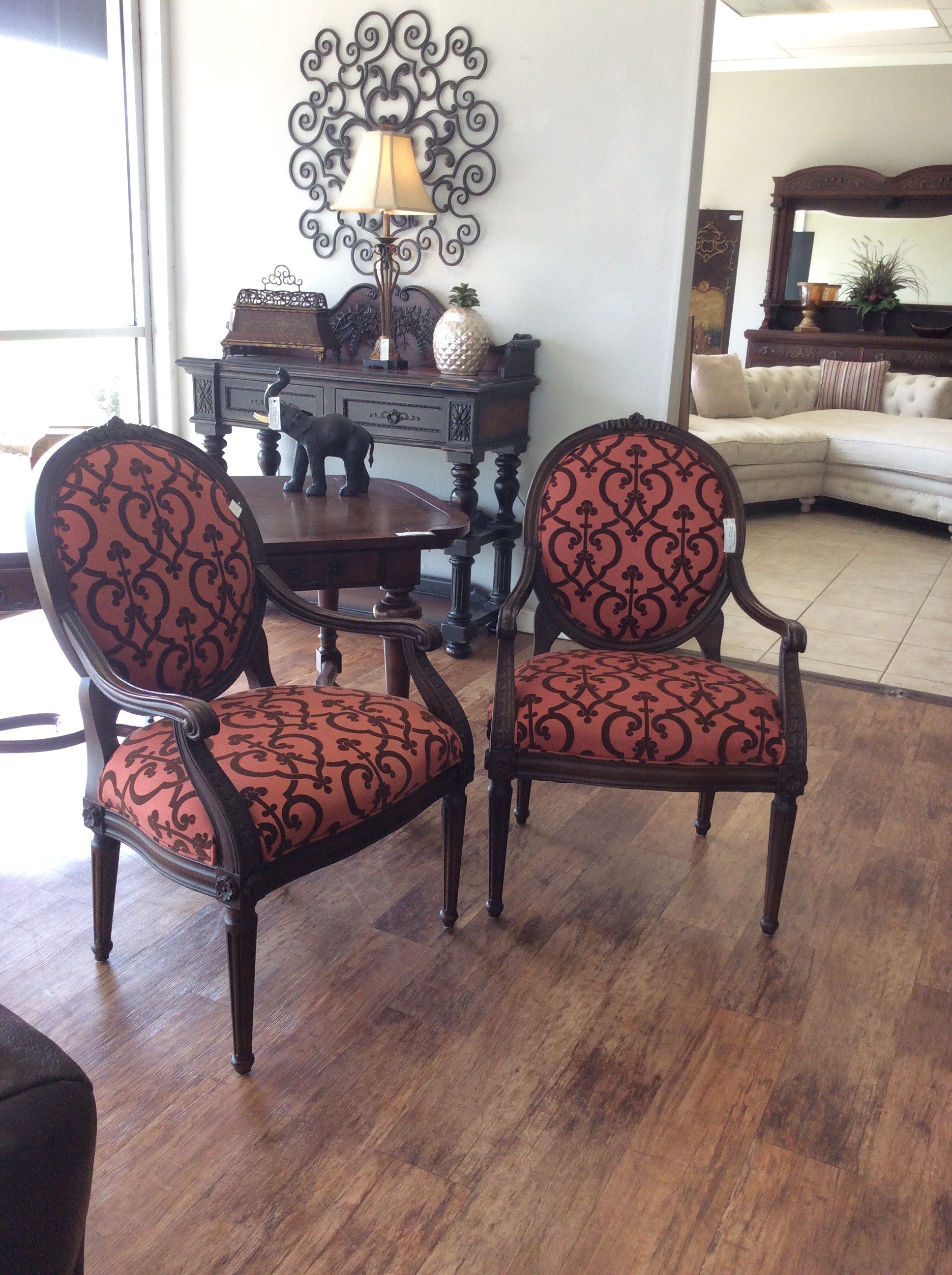 This is a very pretty pair of chairs by Hancock and Moore. They've been upholstered in a lovely scrollwork pattern of persimmon and brown.