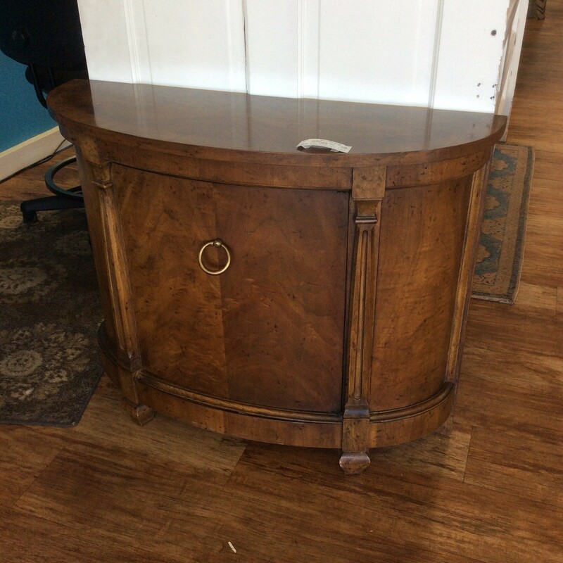 This small half moon end table is made of burlwood and includes 1 adjustable shelf.