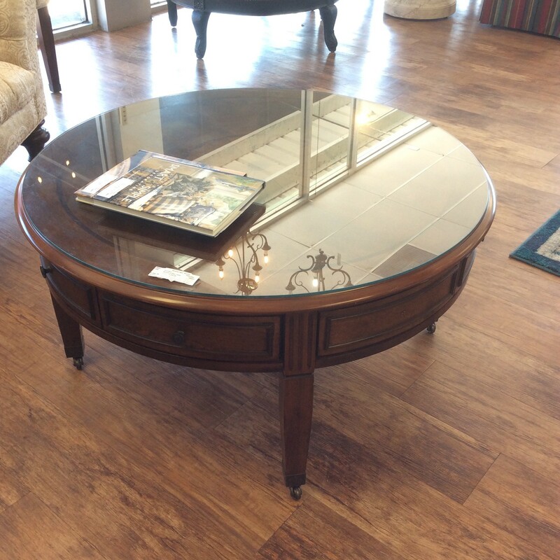 Sweeeet!! This coffee table is vintagy, elegant and feminine. It features a lovely dark wood finish and sits on casters. It includes a glass top and can be used either way. The tabletop has a patterned inlay reminiscent of times gone by and  has 4 drawers. Best of all, there is a matching pair of end tables priced separately.