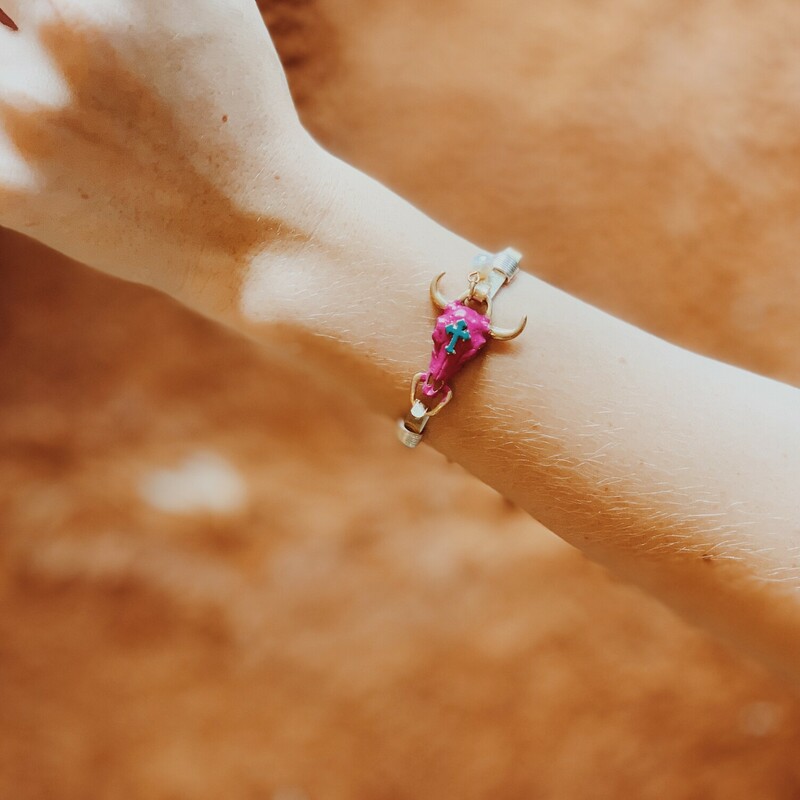 Pink Cow Skull Bangle. Pink skull with turquoise cross. Pearl accent. Silver and gold tones.