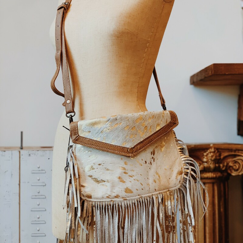 This stylish cowhide, fringe bag adds flare to any outfit! It measures 8 inches by 11 inches and has two extra pockets. Available in two different colors!