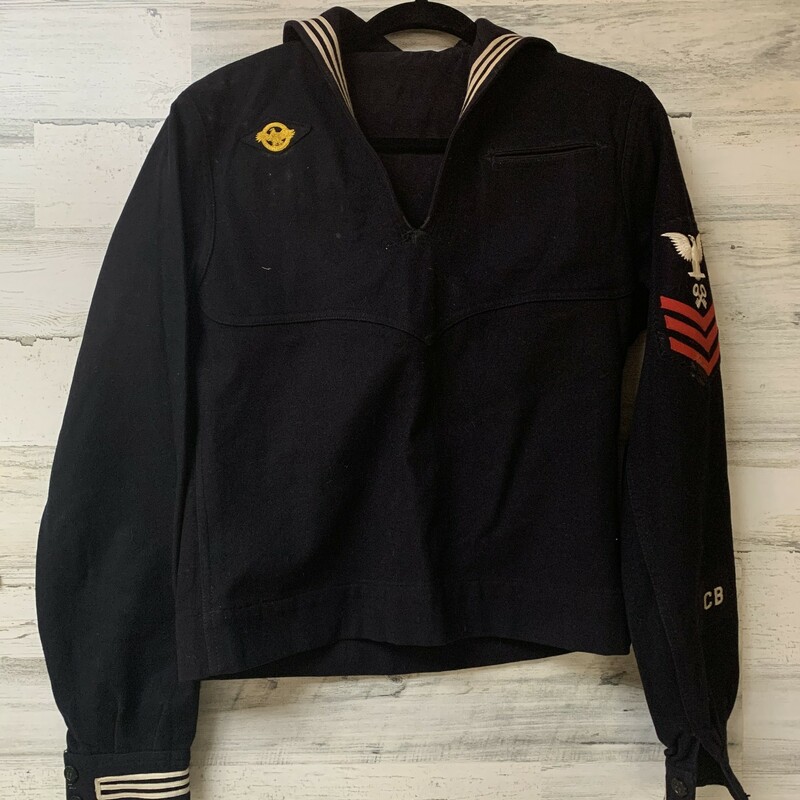 This is a WWII US Navy winter blues uniform. The uniform was called ''cracker jacks.' The gold colored eagle is a honorable discharge patch, it was called a ''Raptured Duck.'' It was required to be placed on their uniform upon their honorable discharge before they were allowed to come home. This sailor was a First Class Petty Officer/Store Keeper.

There is no size, pants missing two buttons. Wool, Have a visual deffects, lints. Please note that this item is a vintage piece of history and condition prettu fair for its age.
Dimensions approx  - Jumper widht chest: 19'', hip widht 18 1/2'', sleeve lenght 21'', arm hole depht 8 1/2''
Pants/Walker - waist 14'', inseam 30 1/2'', outseam 42 1/2''

Please make sure to look at all the pictures.
Thank you so much for your business!