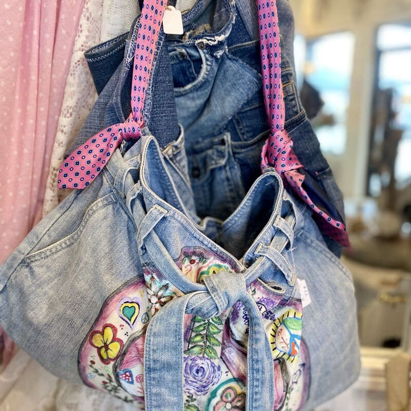 This is an adorable boho denim handbag with a colorful hand painted peace sign.