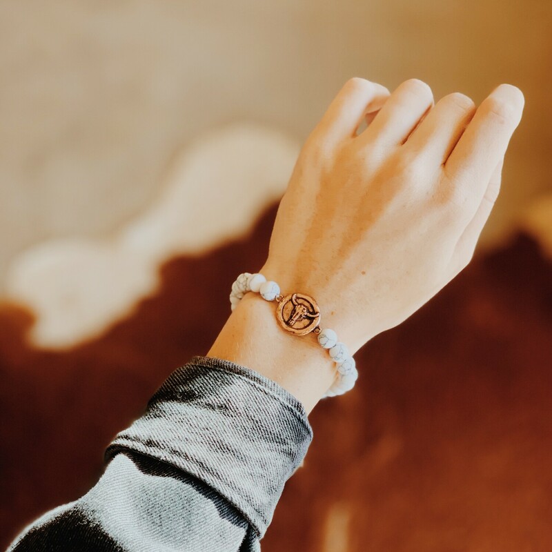 The white marbled beads on this bracelet look so great with the copper bull! Snag yours today!