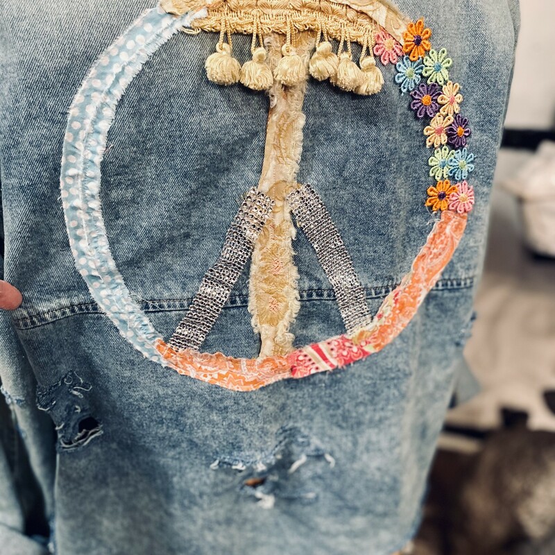 This awesome distressed denim jacket is embellished with a colorful peace sign and worn edgy pieces. Itâ€™s a manâ€™s size medium 38/40 allowing the perfect oversized look.