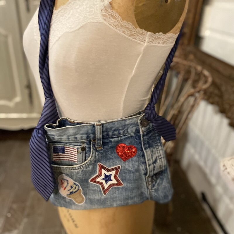 This super cute shoulder bag is handmade from old distressed Aeropostale jeans. Itâ€™s adorned with colorful fun patches including hearts; stars and and ice cream cone.  There are various pockets. The bag is 12 inches across and 9 inches tall. The strap is adjustable. Itâ€™s plenty large enough for a phone and many other various items.