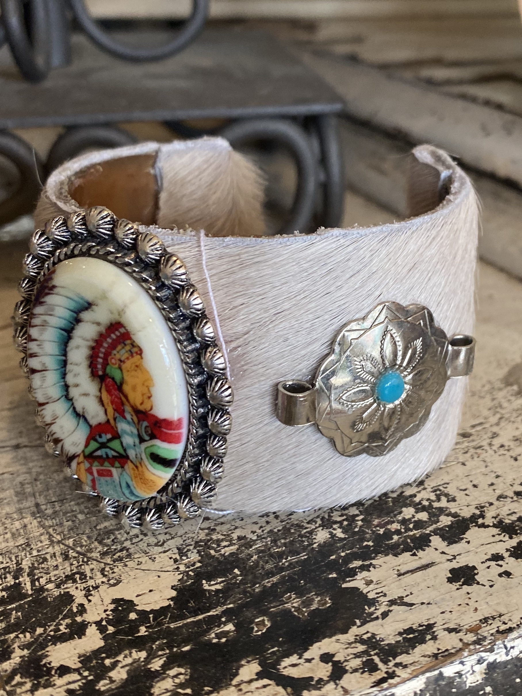 This is a one of a kind handmade cowhide cuff bracelet with Native American and Western touches.