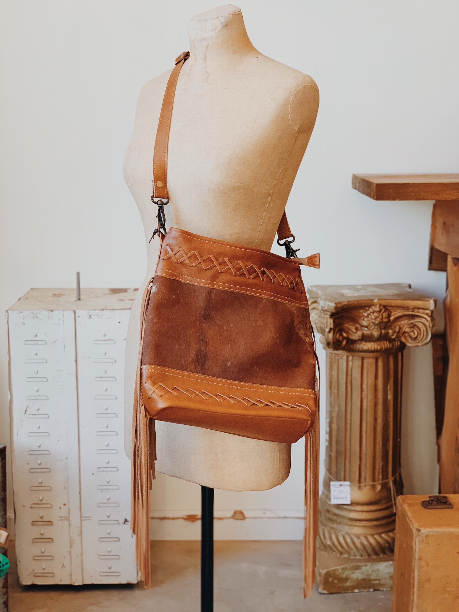 Myra purses are made from quality leather and cowhide! This purse is fabric lined and three inside pockets, as well as one outside pocket!
Measurements: 12 inches tall, 13 inches wide, 3 inches deep
