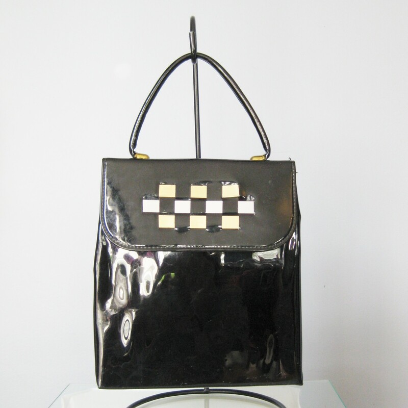 super cute vintage bag in black patent leather
Top Handle, slim style
Three metal foil strips are woven into the flap for decoration.  Two 'gold' ones and a 'silver' one in the middle
No tags
Faille Lining
Snap closure

The bag is in great shape with some imperfections on the patent leather. No gashes but some dull areas

Width: 8.5in
Height: 9 1/2in
Depth: 2;5in
Handle drop: 4in

Thanks for looking!
#13999