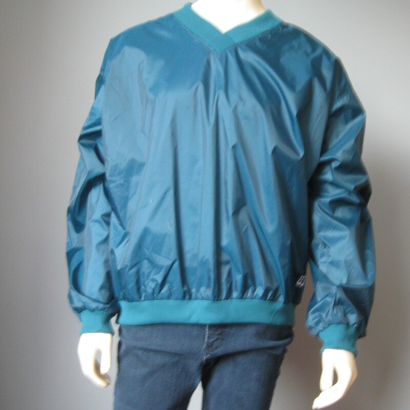 Never worn , still has the tags on.
Country Club type nylon pullover windbreaker from
Wilson's

Please note this item is TEAL GREEN not turquoise blue as it appears in the photos - second photo is edited to get it closer to the actual color.
Sweater Cuffs, neck and waist
Venting zipper on one side
100% Nylon shell
100% Cotton feel poly lining
Marked Size XL
Flat measurements:
armpit to armpit; 28 1/2in
width at hem: 22in
length: 27 1/2in

Perfect brand new condition.

Thanks for looking!