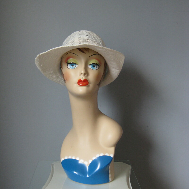 Sporty yet ladylike this summery straw hat is made of an open weave fabric.  It's not stiff but does hold its shape.  Darling floral embroidery on one and a jaunty turn up brim that extends in front to sheild the eyes from the sun.  Inner hat band measures 23in, this is large, my mannequin is pretty small so this hat will probably sit a bit higher on your head than on hers.
no labels
Perfect condition.
Thanks for looking!!!
#380
