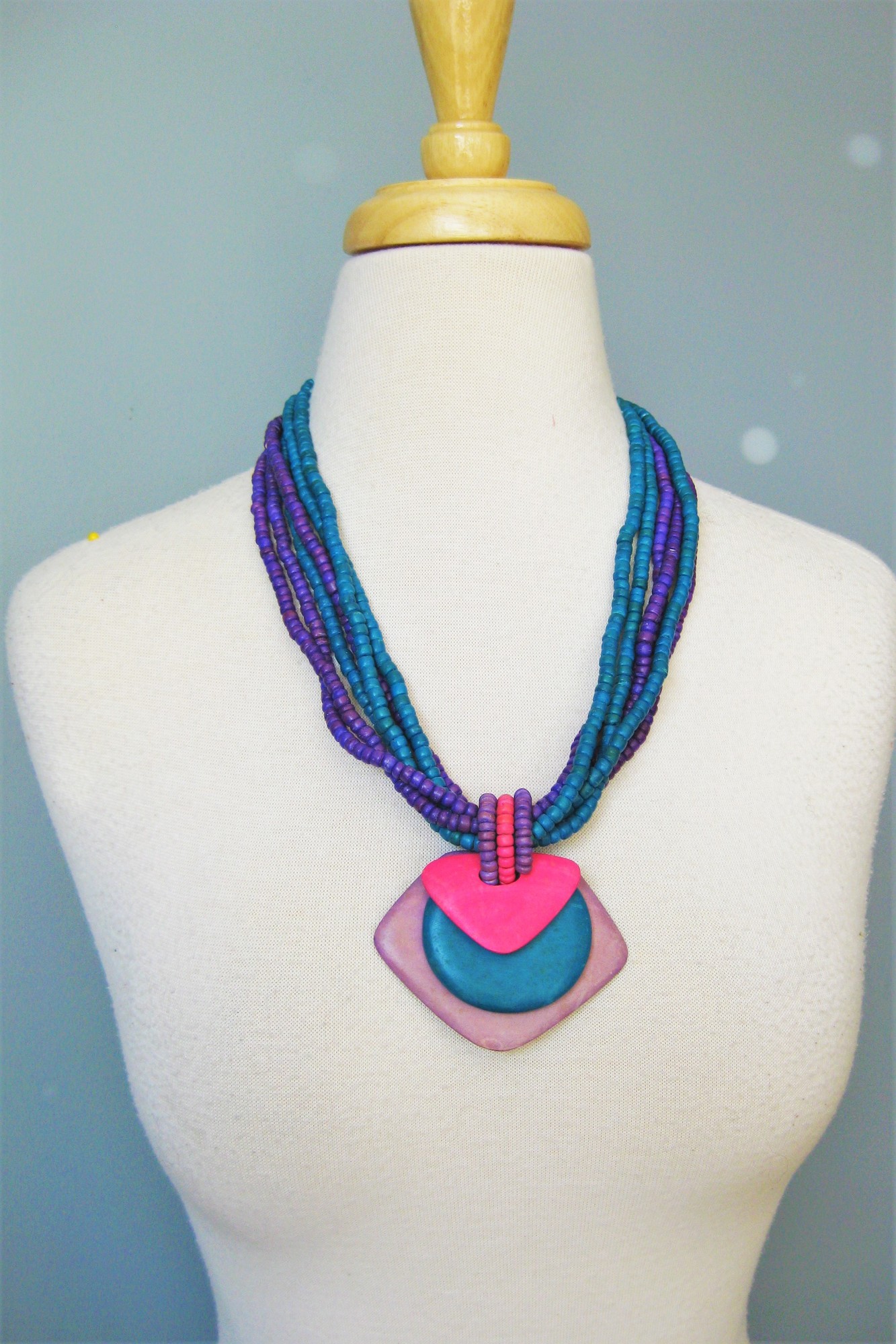 Multistrand Wood Pendant, Purple, Size: None
Quintessental 80s necklace.
You would have worn this to work over a perfectly matching big shouldered silky patterned dress.
It's a multistand pendant necklace with small teal and purple beads and a semi tribal looking pectoral pendant in pink, teal and lavender layers.
All wood.

23in long
closes with a hook
thanks for looking!
#40102