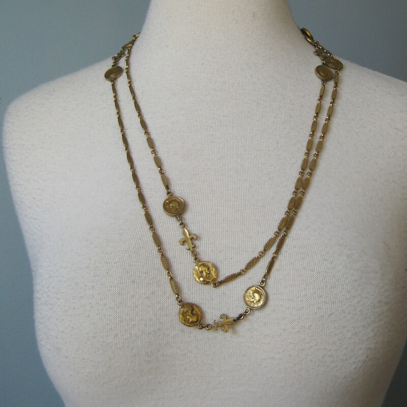 Single strand gold tone necklace from Corocraft
It has tiny ancient style coins with the head of the goddess Minerva, goddess wisdom and strategic warfare.  There are also Fleur de Lis charms.

This is a stately opera length necklace and can be doubled for a shorter look

Thanks for looking!
#41503