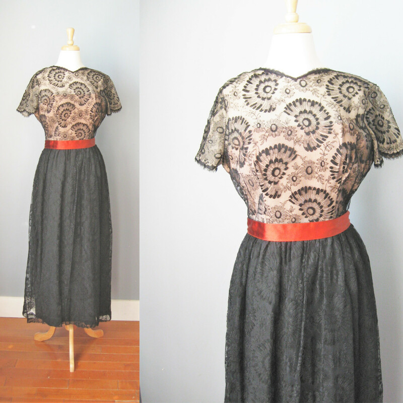 Beautiful black lace gown from the 1960s
by August de Lorenzo for Lee Claire
Bodice is sheer lace w a flesh toned liner
Skirt is fully lined
Waist has a rust colored satin ribbon ending in very long fringed tails at the back
Excellent condition, w a repair to tear in the lace on the skirt
No size tag, please use these flat measurements below to determine if it will fit you.
Should fit about a size 6 person, but def check the measurements
Armpit to armpit: 18.25in
waist: 15in
hip: 25in
length: 54in