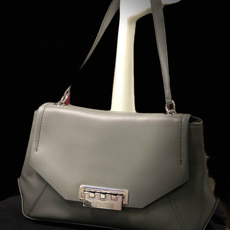 ZAC POSEN Gray Envelope Shoulder Bag
* Envelope design detailed with asymmetrical stitching
* Shoulder strap, 11\" drop
* Push-lock closure
* Protective metal feet
* One outside open pocket
* One inside zip pocket
* One inside open pocket
* Fully lined
* Includes dust bag
* 13\"W X 8.5\"H X 4.5\"D
* Leather
Original Retail Price $495.00
This handbag is preowned and in excellent condition.  Only flaw found was light minor scratches on silver front latch as pictured (barely visible).  No other marks, stains or flaws found.  This bag is beautiful.
