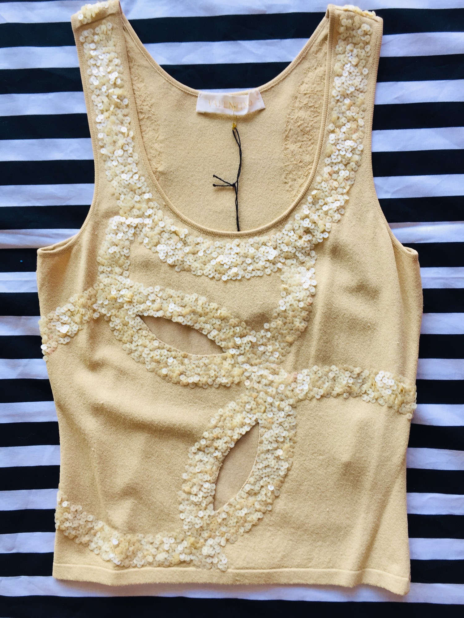 Valentino sleeveless tank with cutouts. This item has a very unique and fun design with detailed sequin work. Size small; Tan