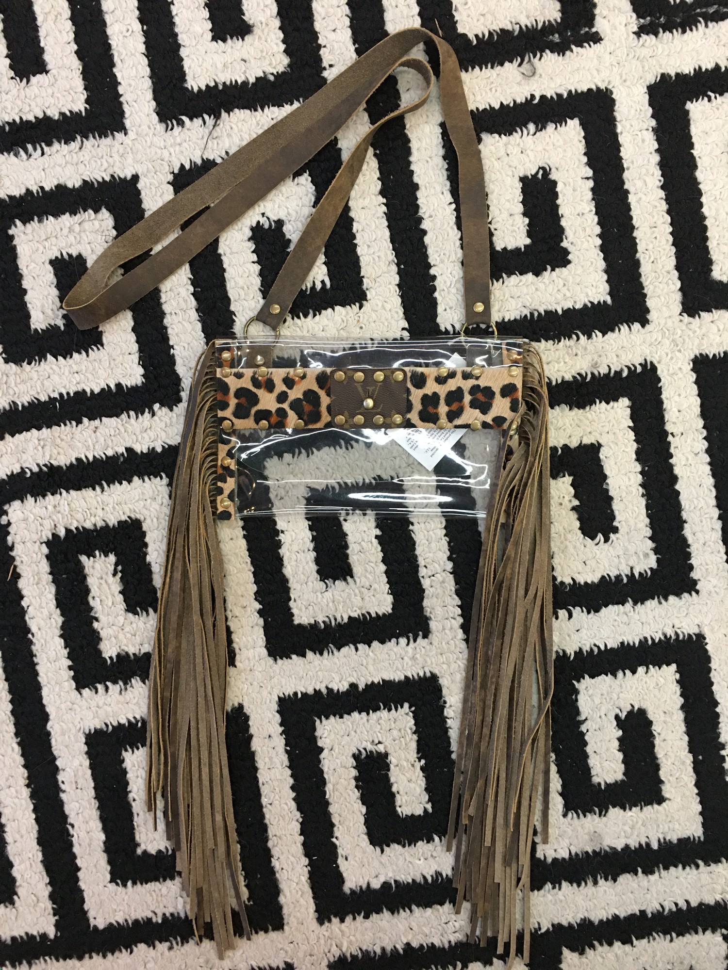 HANDMADE Louis Vuitton clear crossbody. Made with thin, clear plastic, faux cheetah fur, and real leather fringe and strap. This item is staduim approved, so it's perfect for football games, concerts, and other stadium events! This item is made from upcycled Louis Vuitton bags!