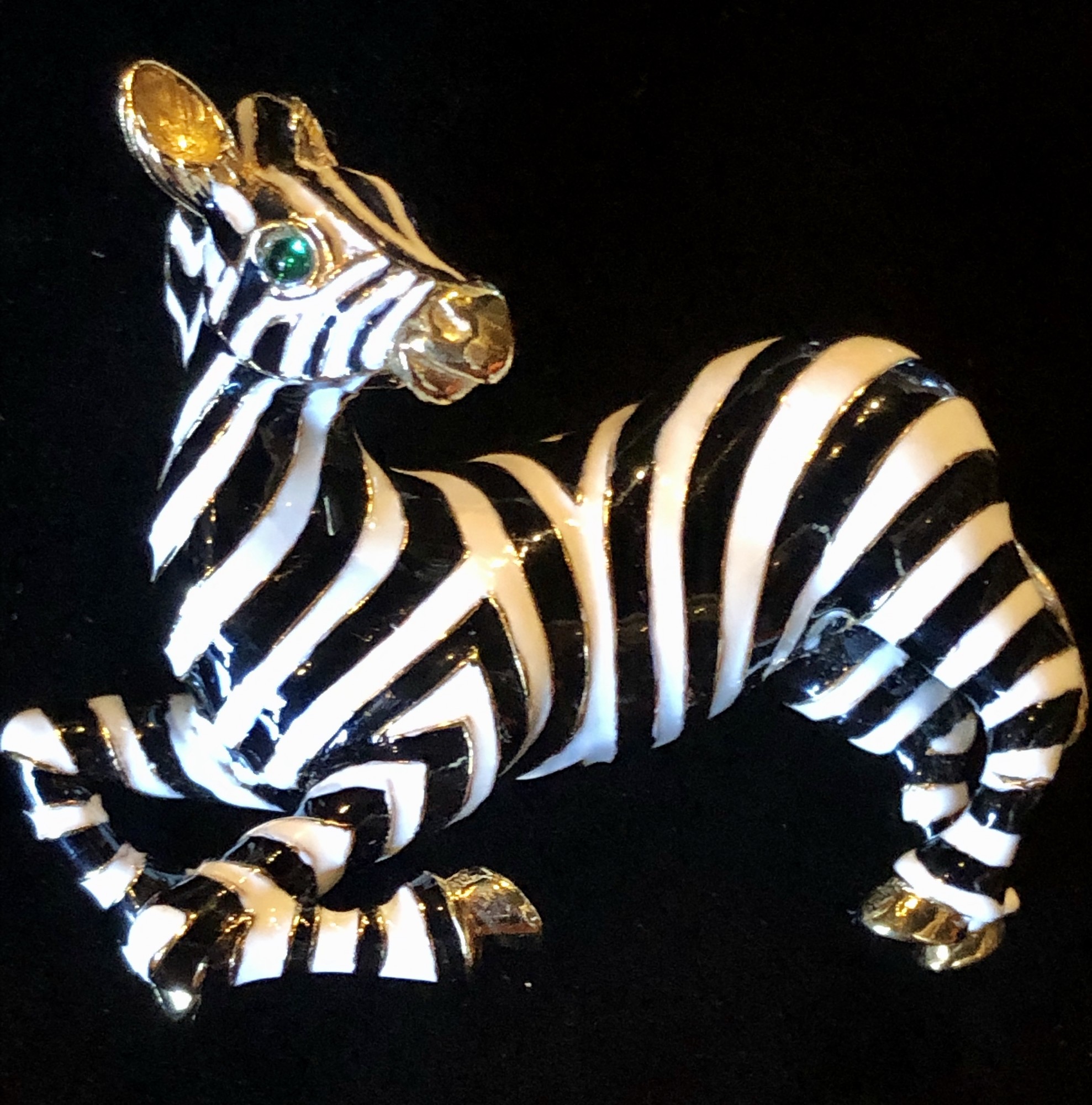 This is a Vintage Ciner Zebra Brooch, gold plate & enameled with green eyes. It's 2 3/4in x 2in and is in perfect condition.
Ciner was founded in 1892, first producing fine jewelry then transitioning to costume jewelry in 1931. All the work was still done by hand. Ciner was known for using 18k gold plating, high-quality glass beads and stones, & rich enameling giving the jewelry a substantial feel and longevity in wear. This emphasis on quality is why costume jewelry collectors prize vintage Ciner pieces today.
