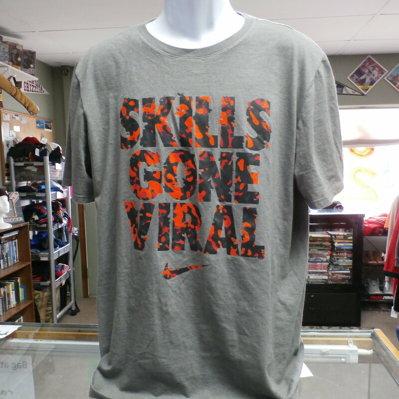 Nike Men's Athletic Cut \"Skills Gone Viral\" Short Sleeve Shirt Gray Size XL #19917
Rating:   (see below)2- Great Condition
Team: n/a
Player: n/a
Brand: Nike
Size: XL - Men's  (Measured: 21\" Wide, length 30\")
Measured: Armpit to armpit; shoulder to hem
Color: Gray
Style: short sleeve; screen pressed; athletic cut; \"Skills Gone Viral\"
Material: 50 Cotton 50 Polyester
Condition: 2- Great Condition - fabric is crisp; screen press has not cracks or peeling; no rips, tears, or stains, slightly stretched fro use and wash; (see photos)
Item #: 19917
Shipping: FREE