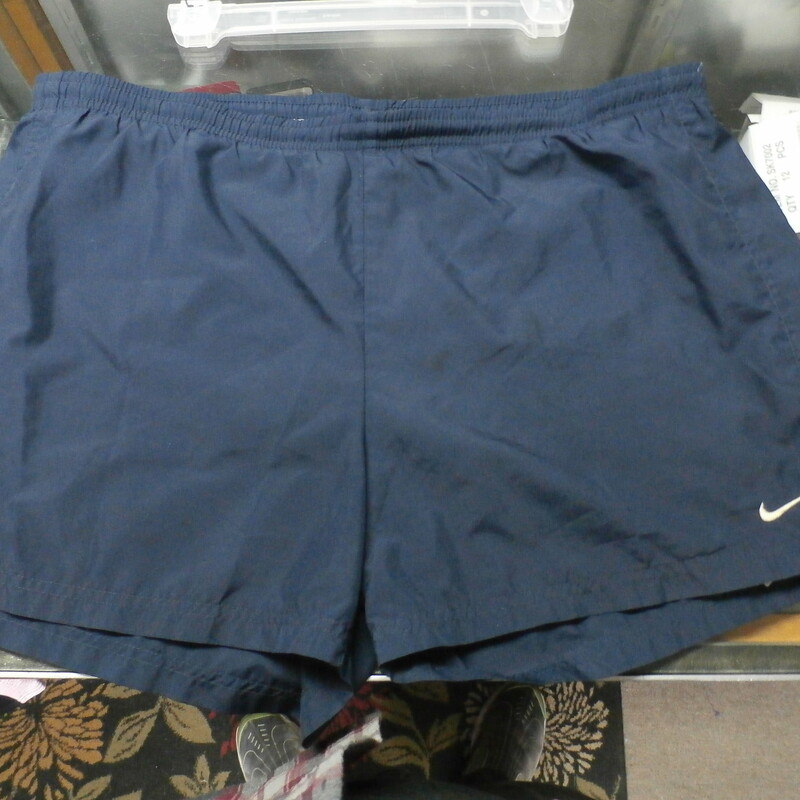 Nike men's shorts blue size large 100% polyester #25898
Rating: (see below) 3- Good Condition
Team: n/a
Player: n/a
Brand: Nike
Size: Men's Large-  (Measured Flat: Waist 19\"; Length 14\"; Inseam 4\")
Measured flat: hip to hip; hip to hem; and groin to hem
Color: blue
Style: elastic waistband with drawstring
Material: 100% polyester
Condition: 3- Good Condition; wrinkled; some pilling and fuzz; material is stretched and worn from wearing and washing; heavy discoloration and fading; no rips or tears; embroidered logo is discolored (see photos)
Item #:25898
Shipping: FREE