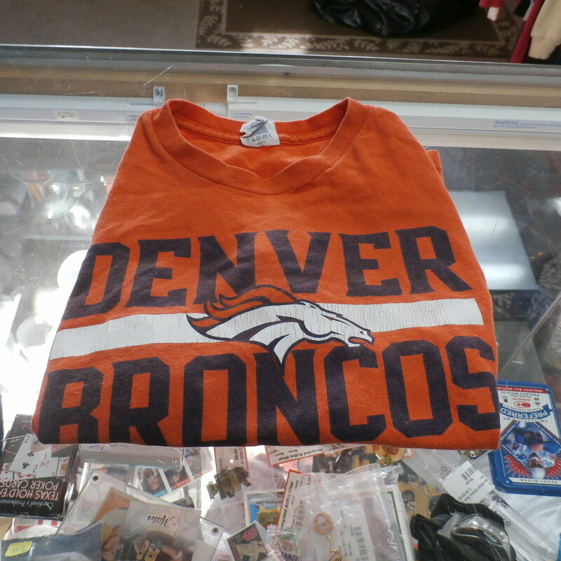 Delta Pro Weight Denver Broncos Orange Youth Size Large Shirt Cotton #26946
Rating:   (see below) 4 - Fair Condition
Team: Denver Broncos
Player: Team
Brand: Delta Pro Weight
Size: Youth Large;  - Boy's (Measured Flat: Across chest 16\", length 19\")
Measured Flat: arm pit to arm pit; top of shoulder to the hem
Color: Orange
Style: Screen pressed T-Shirt
Material:  100% Cotton
Condition: - 4 Fair Condition - Wrinkled; Minor Pilling And Fuzz; light Cracks along logo; Two Small Holes At Seems on neck line
Item #: 26946
Shipping: FREE