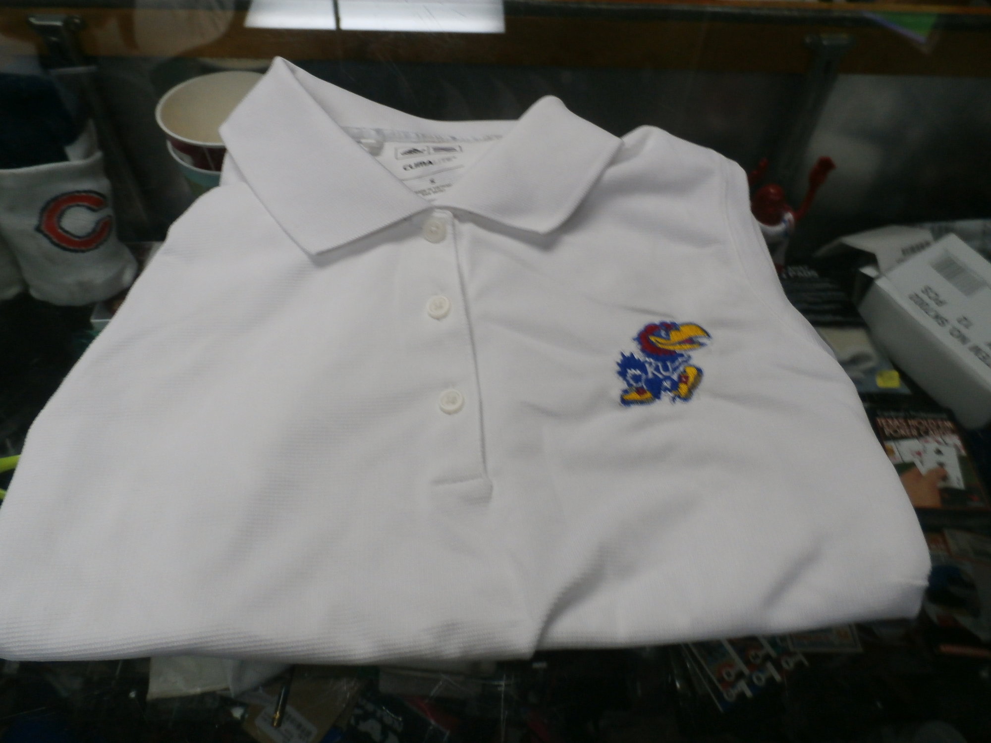 Adidas Kansas Jay Hawks White Women's Polo Shirt Size Small Polyester  #28705
Rating: (see below) 3- Good Condition
Team: Kansas Jay Hawks
Player: Team
Brand: Adidas
Size: Small - Women's(Measured Flat: across chest 17\", length 22\")
Measured flat: armpit to armpit; top of shoulder to the bottom hem
Color: White
Style: women's polo; sleeveless; embroidered; collared with buttons
Material: 100% Polyester
Condition: 3- Good Condition - wrinkled; Minor Pilling and Fuzz; stains around the neck mostly interior of the shirt;
Item #: 28705
Shipping: FREE