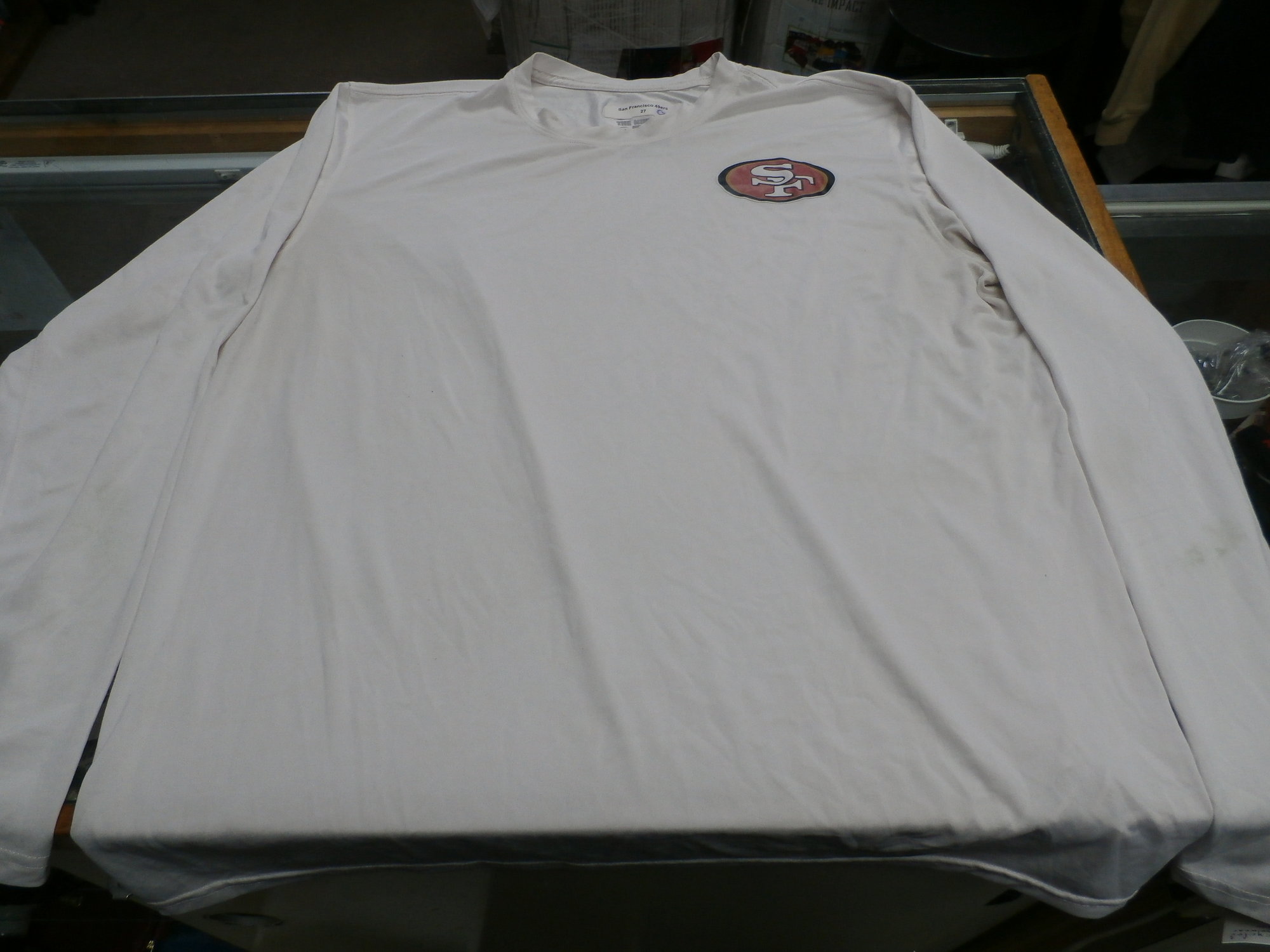 SF 49ers LS, White, Size: Large
Nike Men's San Francisco 49er's long sleeve shirt white size Large poly #28718
Rating: (see below) 4- Fair Condition
Team: San Francisco 49er's
Player: N/A
Brand: Nike
Size:  Men's Large  (Measured Flat: Across chest 21\"; Length 27\")
Measured Laying Flat: armpit to armpit; top of shoulder to bottom hem
Color: White
Style: Long sleeve shirt; Screen pressed
Material: 100% Polyester
Condition: 4- Fair Condition: wrinkled; minor pilling and fuzz; discoloration from use; some light staining on front; black stains on the right sleeve; light staining on left sleeve;
Item #: 28718
Shipping: FREE