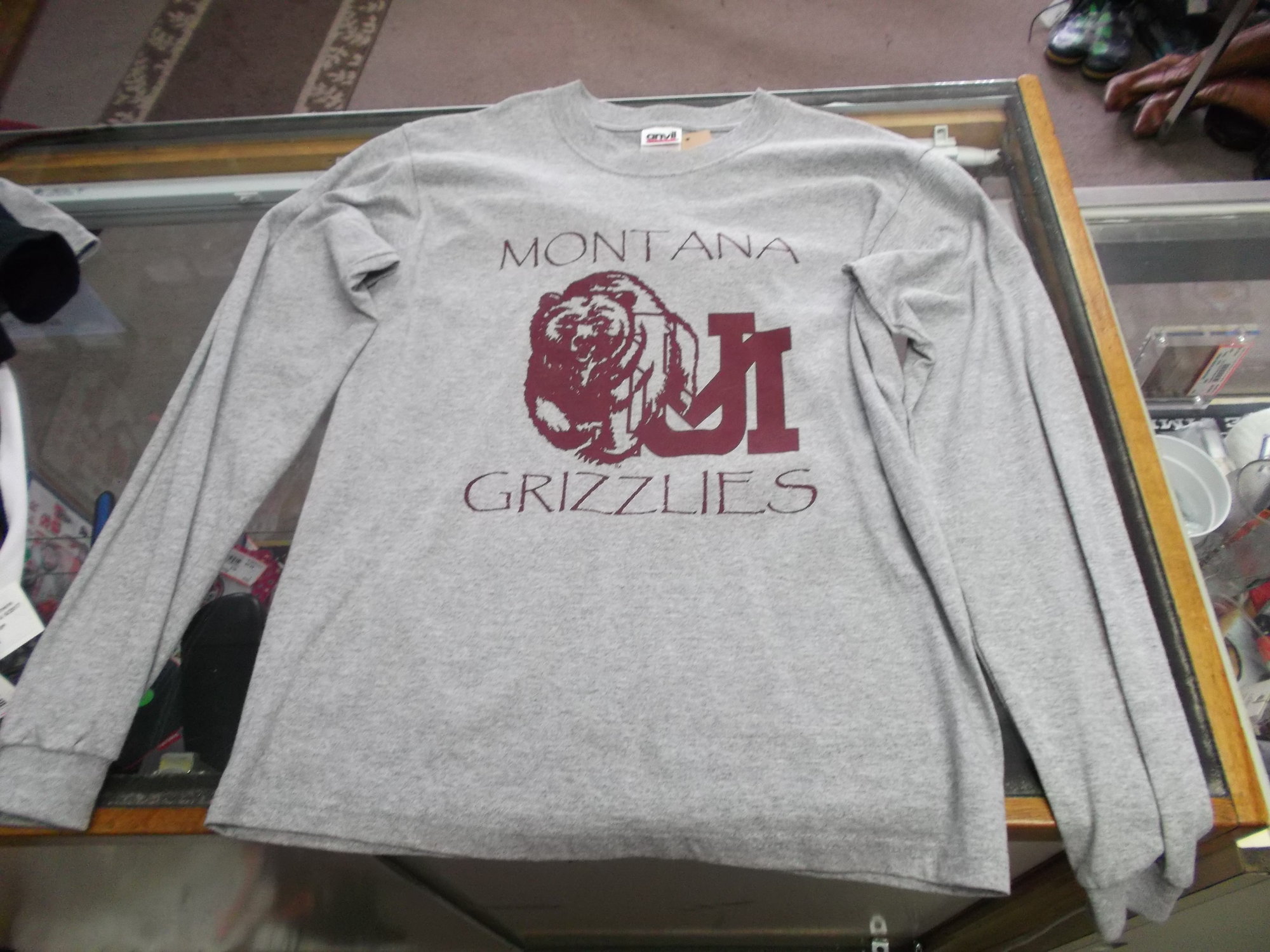 Montana Grizzlies YOUTH Anvil Long Sleeve Shirt Size Large Gray #8267
Rating:   (see below) 3 - Good Condition
Team: Montana Grizzlies
Player: N/A
Brand: Anvil
Size: Large - YOUTH(Measured Flat: Across chest 17\"; length 25\") 
Color: Gray
Style: Long sleeve screen pressed shirt
Material: 90% Cotton 10% Polyester
Condition: - Good Condition - wrinkled; Pilling and fuzz is present; Material feels coarse; Front part of the left side of the collar is stained; Definite signs of use; Logo looks great; No rips or holes(See Photos for condition and description)
Shipping: $3.37
Item #: 8267 