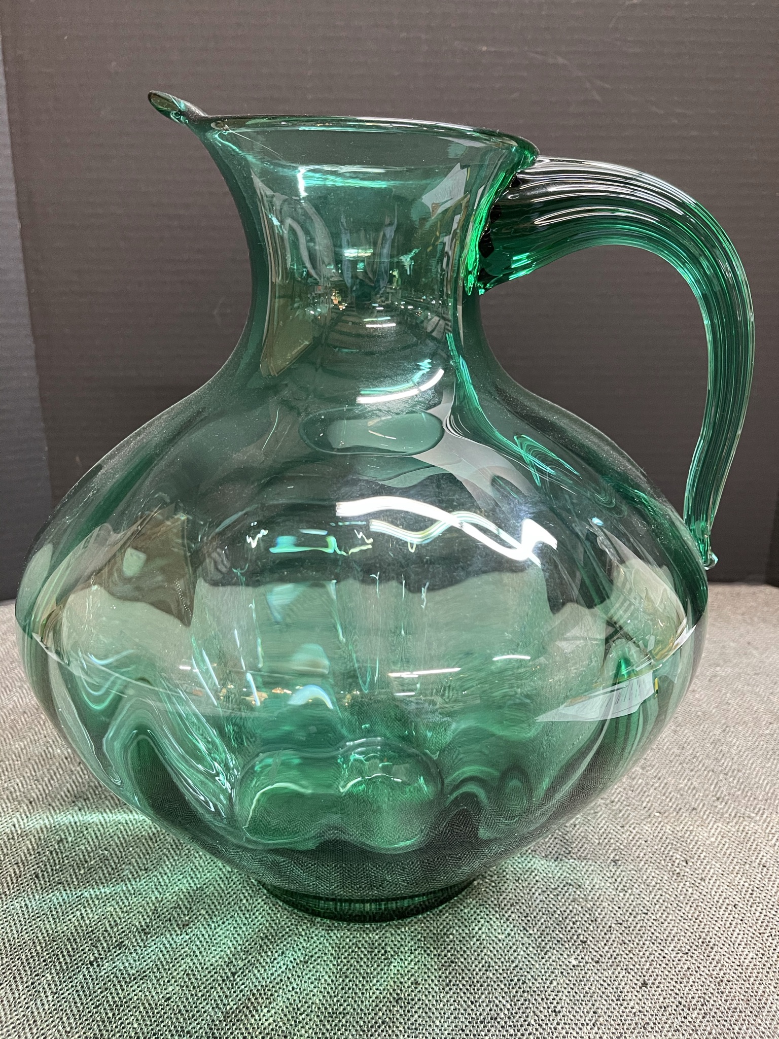Blenko 14 inch tall pitcher. The fresh green color imparts energy and is a joy to look at! This beautiful vessel has no chips and is in excellent condition.