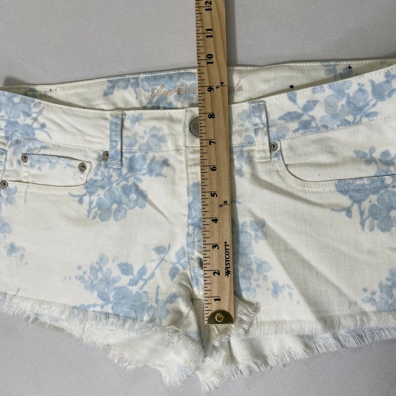 100-183 American Eagle, White, Size: 10 white fringe jean shorts with blue flower pattern