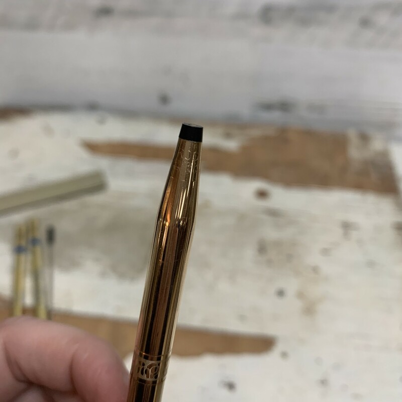 Vintage 1/20 14k yellow gold plated pen. Comes with original cowhide pen purse made by Cross.<br />
Have two refill inks in blue and one in black. Black ink doesn't have a cover. I don't know how much ink is in each container, but they all write.<br />
Pen measures approx. 5 1/4'' long, 1/4'' diameter.<br />
Pen purse measures approx. 5 1/2'' x 1 1/4''.<br />
Overall in a good vintage condition. Have a light vintage wear. Please make sure to look at all the pictures for a closer visual.<br />
Please note that this item is vintage and you will experience vintage wear. You will receive item as shown in the pictures.<br />
Thank you.