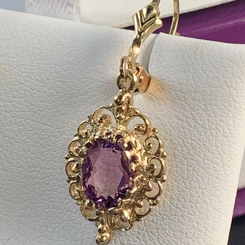 Oval Amethyst with Filigree Border Dangle Earrings<br />
Lever back style. 8 x 6mm. Medium color.<br />
$355