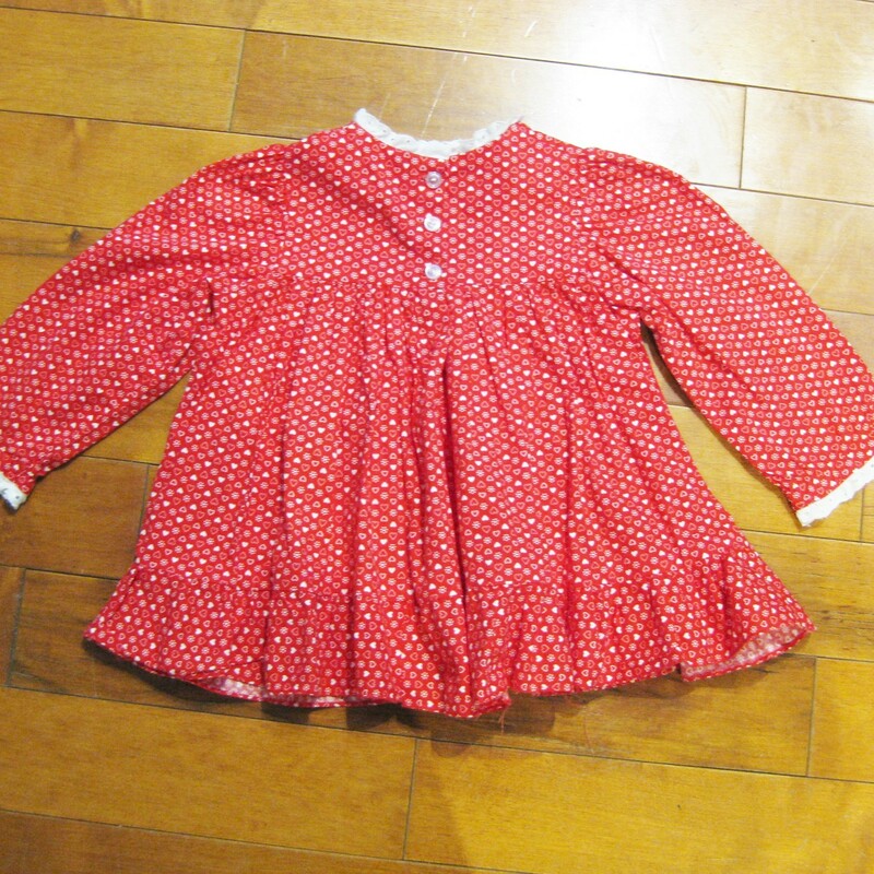 Darling vintage baby dress in red and white cotton with white eyelet lace trim at the neck and sleeves end.<br />
It has three buttons in the back.<br />
Should fit up to one year old.<br />
Flat measurements:<br />
chest: 12.75in<br />
length: 15in<br />
<br />
Amazing condition!<br />
thanks for looking!<br />
#16076
