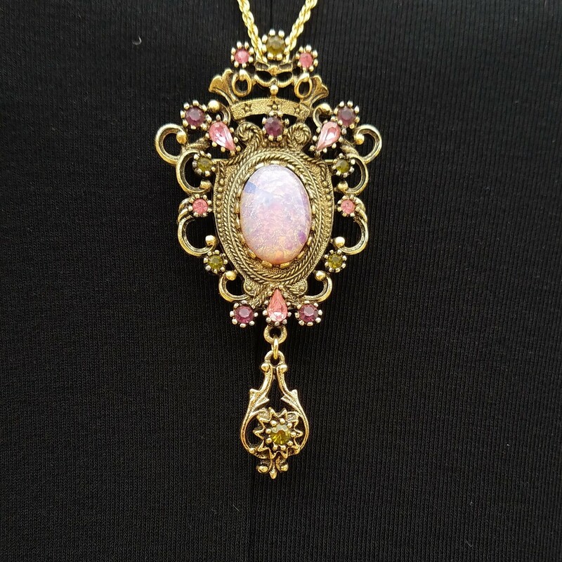 BEAUTIFUL BROOCH/PENDANT
RICH COLORS OF PURPLE, PINK AND GREEN.  CENTER IS OPAL IN COLOR.  Sarah Coventry pieces  are made from both silvertone and gold-colored metals, often set with large faux pearls and other gemstone simulants. Sarah Coventry jewelry was mospopular during the 1950s and 1960s and continued to be offered at home parties for a few years