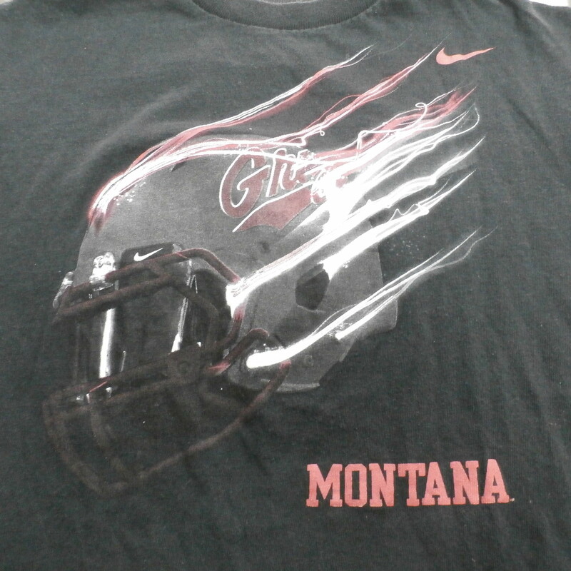 Montana Grizzlies Nike YOUTH Short Sleeve Shirt Size Large Black #26950<br />
Rating: (see below) 3 - Good Condition<br />
Team: Montana Grizzlies<br />
Player: N/A<br />
Brand: Nike<br />
Size: Large YOUTH - (Measured Flat: chest 17\", length 22\")<br />
Measured laying flat: armpit to armpit; top of shoulder to bottom hem<br />
Color: Black<br />
Style: screen pressed shirt<br />
Material: Cotton? - Tag is hard to read<br />
Condition: 3 - Good Condition: faded and discolored; pilling and fuzz; material feels coarse; material is stretched; screen pressed tag is faded and hard to read; definite signs of use<br />
Item #: 26950<br />
Shipping: FREE