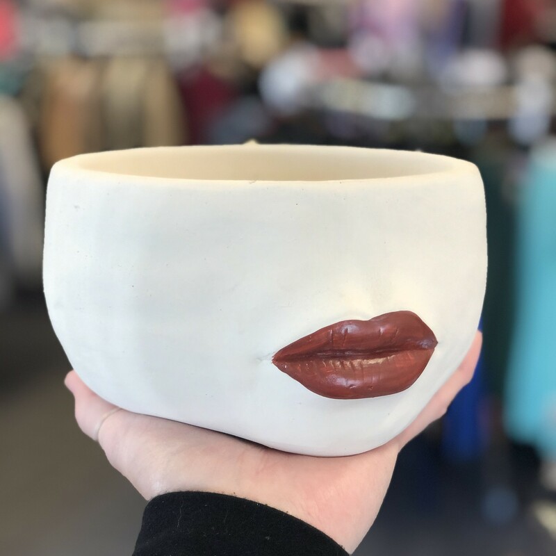 Give your favourite plant an unforgettable accent with this stunning Large Red Lips Planter. Crafted out of cement, this ivory planter features a luscious pair of three-dimensional, rudy-red pouty lips to highlight your most vibrant flowers or foliage. Smaller size also available. 7 inch Diameter