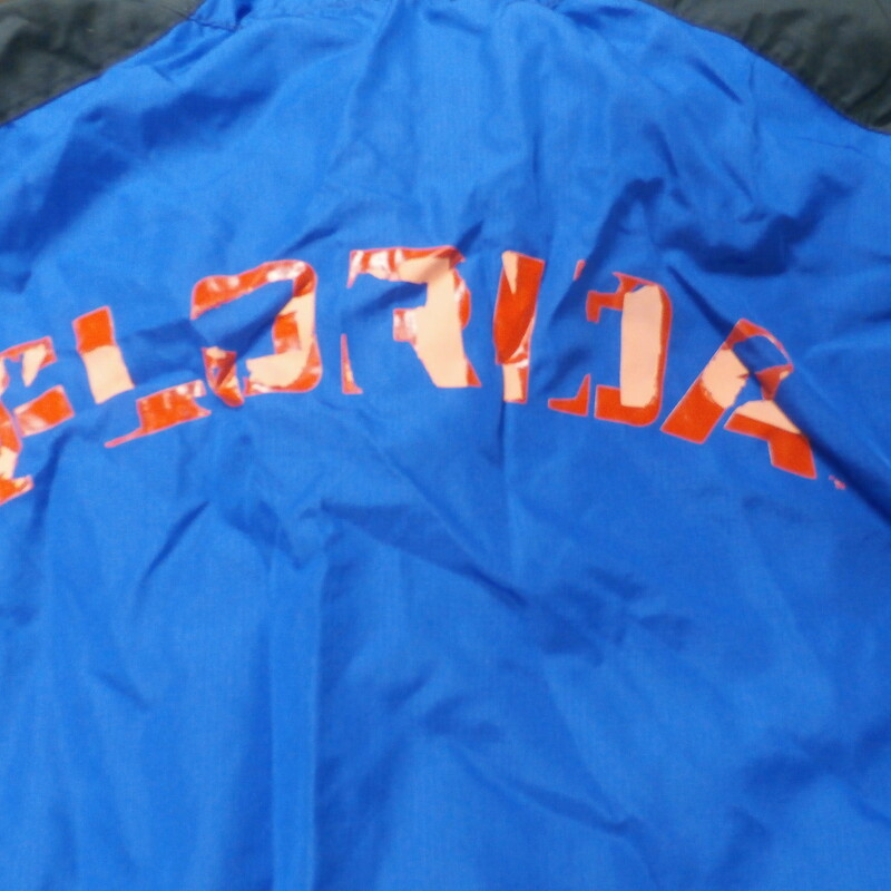 Florida Gators Men's pullover jacket blue polyester partial zip size Large #27847
Rating: (see below) 4- Fair Condition
Team: Florida Gators
Player: Team
Brand: Nike
Size: Men's Large- (Measured Flat: Across chest 24\"; Length 30\")
Measured Flat: underarm to underarm; top of shoulder to bottom hem
Color: Blue with black shoulders
Style: short sleeve; screen pressed; pullover; partial zip
Material: 100% polyester
Condition: 4- Fair Condition - wrinkled; the screen pressed logos front and back are badly ruined from a hot dryer; they are partially stuck together and coming off and they feel hard
Item #: 27847
Shipping: FREE