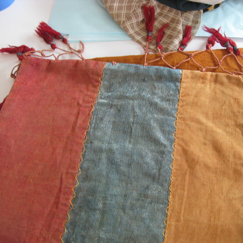 Antique Table Runner from an estate in upstate New York<br />
84in long x 15in wide<br />
lustrous fabrics (my best guess is cotton) in teal, coppery orange & cranberry.<br />
Fancy fringe at each end<br />
fully lined on the back side<br />
quite substantial in weight<br />
<br />
CONDITION:  holes in the lining as shown<br />
the tassels in the fringe are somewhat felted, as though it was put through the wash/dry at some point.<br />
the brushed texture of the blue and copper fabric is worn flat from the ends in by about 10in<br />
<br />
thanks for looking!<br />
#14504