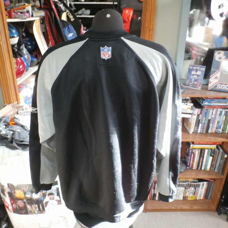 Oakland Raiders Reebok sweater black size Large polyester blend #28431
Rating: (see below) 3- Good Condition
Team: Oakland Raiders
Player: n/a
Brand: Reebok
Size: Men's Large- (Measured Flat: Across chest 26\"; Length 30\")
Measured Flat: underarm to underarm; top of shoulder to bottom hem
Color: black
Style: long sleeve; embroidered
Material: 80% polyester  20% cotton
Condition: 3- Good Condition: minor wear; some loose threads on front embroidery and some of the white parts are coming loose (see photos)
Item #: 28431
Shipping: FREE