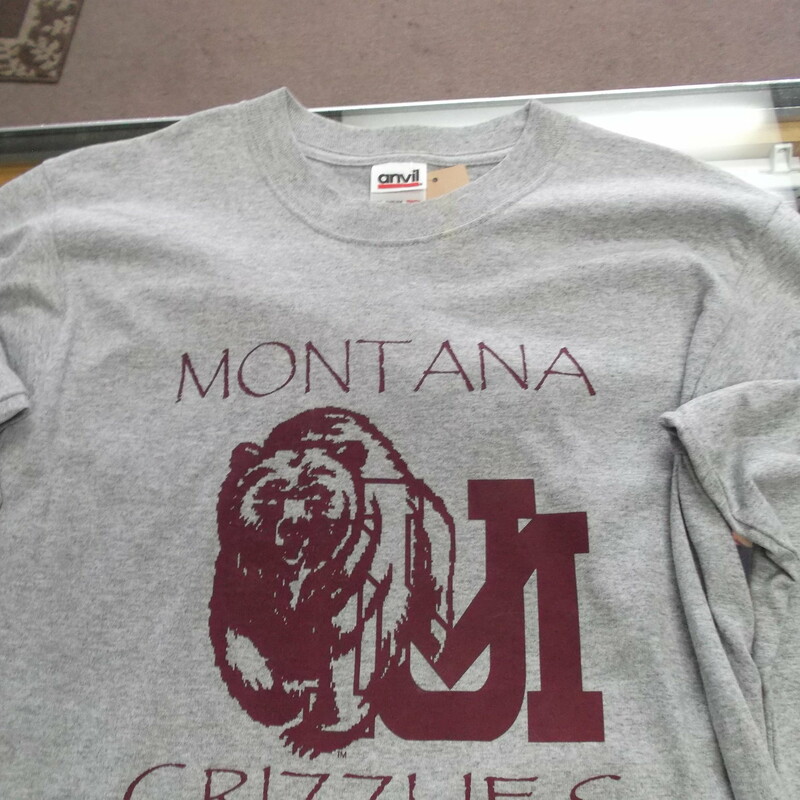 Montana Grizzlies YOUTH Anvil Long Sleeve Shirt Size Large Gray #8267<br />
Rating:   (see below) 3 - Good Condition<br />
Team: Montana Grizzlies<br />
Player: N/A<br />
Brand: Anvil<br />
Size: Large - YOUTH(Measured Flat: Across chest 17\"; length 25\") <br />
Color: Gray<br />
Style: Long sleeve screen pressed shirt<br />
Material: 90% Cotton 10% Polyester<br />
Condition: - Good Condition - wrinkled; Pilling and fuzz is present; Material feels coarse; Front part of the left side of the collar is stained; Definite signs of use; Logo looks great; No rips or holes(See Photos for condition and description)<br />
Shipping: $3.37<br />
Item #: 8267 