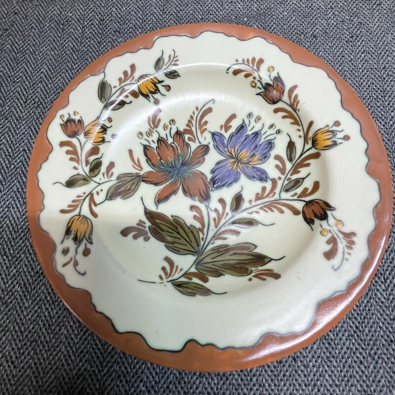 Gouda Dago plate. Gorgeous plate boasts dandelion; spice; orchid and sage hues. Plate measures almost 7 inches and is in beautiful;  ready for display condition! Signed and numbered! Circa 1950â€™s