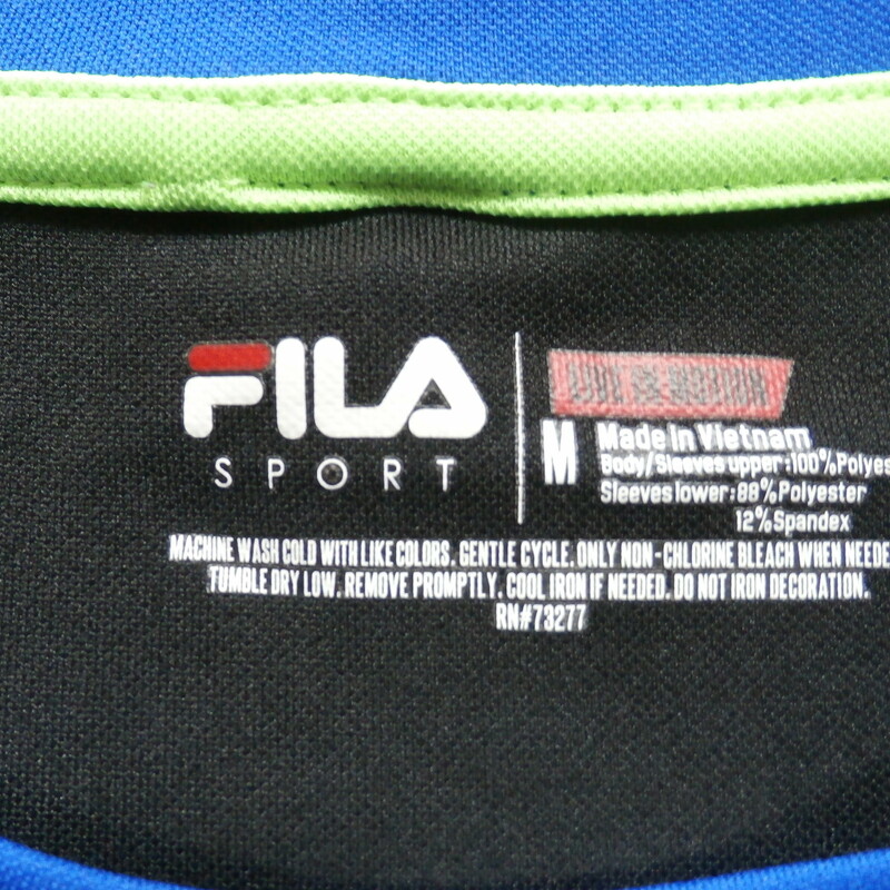 FILA Men's short sleeve shirt size medium blue and black polyester #30102
Rating: (see below) 3- Good Condition
Team: n/a
Player: n/a
Brand: FILA
Size: Men's medium- (Measured Flat: Across chest 20\"; Length 26\")
Measured Flat: underarm to underarm; top of shoulder to bottom hem
Color: blue and black
Style: short sleeve; screen pressed
Material:   100% polyester
Condition: 3- Good Condition: wrinkled; minor pilling and fuzz; item is slightly stretched from use; some discoloration;
Item #: 30102
Shipping: FREE