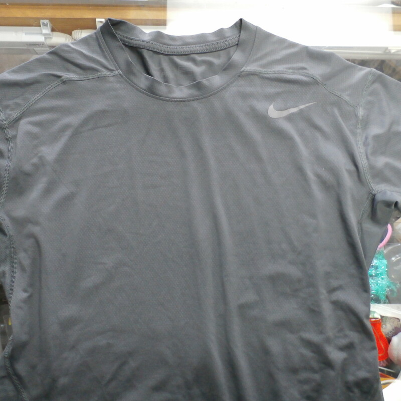 Men's Nike short sleeve compression shirt gray size XL #31404<br />
Rating: (see below) 4- Fair Condition<br />
Team:  N/A<br />
Player:N/A<br />
Brand: Nike<br />
Size: Men's XLarge- (Measured Flat: Across chest 18\"; Length 29\")<br />
Measured Flat: underarm to underarm; top of shoulder to bottom hem<br />
Color: gray<br />
Style:    short sleeve; screen printed; compression<br />
Material:  92% polyester 8% spandex<br />
Condition: 4- Fair Condition: wrinkled; minor pilling and fuzz; stretching from use; some discoloration; a few small snags;<br />
Item #: 31404<br />
Shipping: FREE
