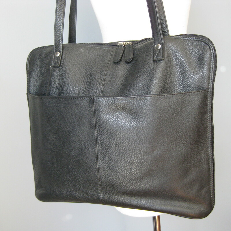 Sleek black leather work tote from Latico.<br />
Slim profile with silver metal zippers that allow the bag to expand as needed.<br />
Double straps<br />
Zipper closure at the top<br />
Card slots, pen holders and middle zipper pocket inside<br />
large outside slip pocket<br />
Made in India<br />
Excellent condition with a touch of wear at one side near the bottom as shown.<br />
<br />
16in x 12.75in x 3.5in<br />
<br />
thanks for looking!<br />
#39225