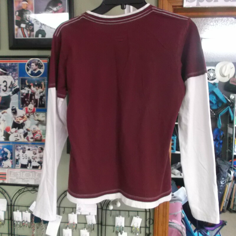 Montana Grizzlies Women's LS Shirt maroon size Medium Pro Edge 100 Cotton # 7551
Rating:   (see below) 3 - Good Condition 
Team: Montana Grizzlies
Player: Team
Brand: Pro Edge
Size: Medium - Women's(Measured Flat: Across Chest 17\"; Length 21\") armpit to armpit and Top of shoulder to the bottom hem
Color: Maroon
Style: Long Sleeve shirt; screen pressed
Material: 100% Cotton  
Condition: - Good Condition - wrinkled; Material is faded and discolored; Pilling and fuzz is present; white fabric is not as white as it was new; signs of use(See Photos for condition and description)
Shipping: $3.37 
Item #: 7551
