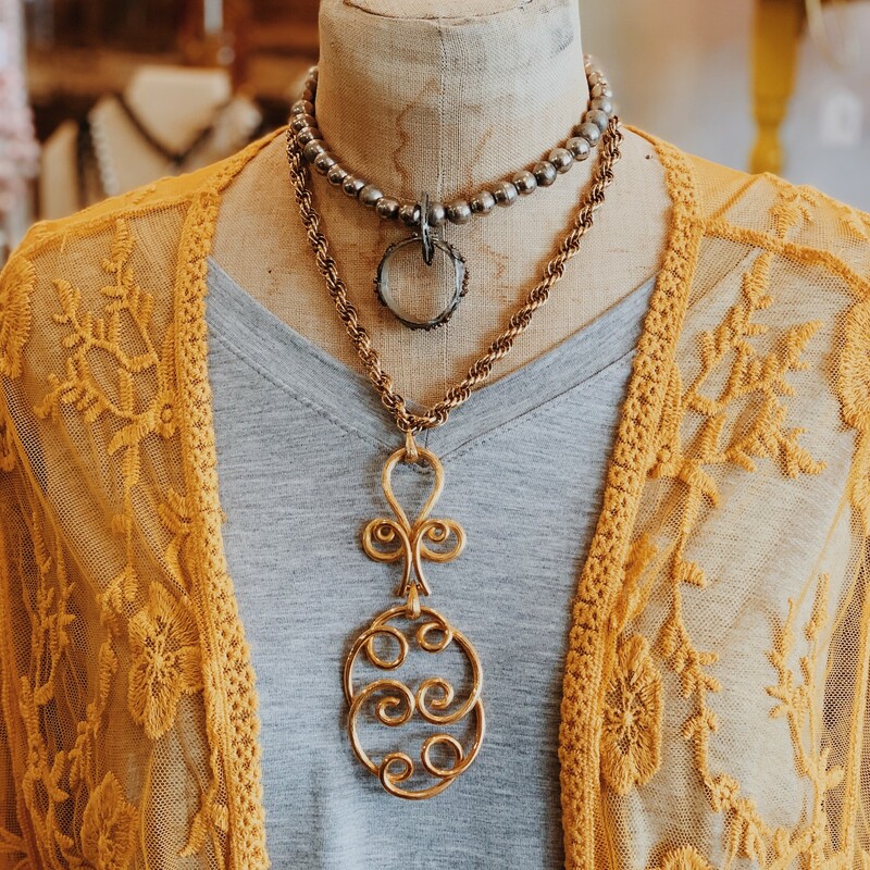 This gold necklace is such a unique piece. Perfect for any eclectic styles out there!