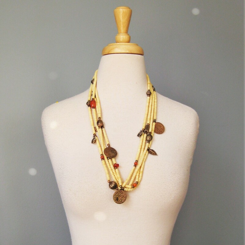 Wood And Brass, Ivory, Size: None
Tribal style necklace made from multiple strands of ivory and orange beads, metal coins and charms

Wear as shown or twist it into a choker length torsade.\\


28.75in long
closes with a silver toned hook

thanks for looking!
#40106