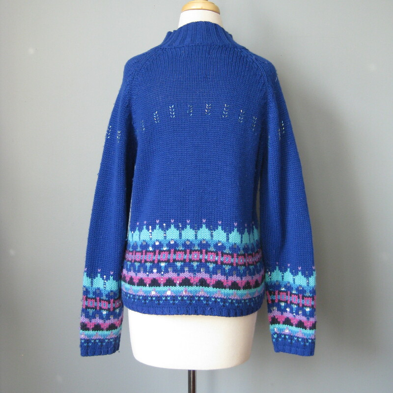 Acrylic and lambswool blend ski sweater by St. John's Bay from the 1980s<br />
So cute in royal blue with touches of lavender and a sprinkling of bugle beads<br />
small section of missing beads as shown<br />
Marked size medium petite<br />
flat measurements:<br />
armpit to armpit: 18.75in<br />
length: 20in<br />
<br />
made in Hong Kong<br />
<br />
thanks for looking!<br />
#39252