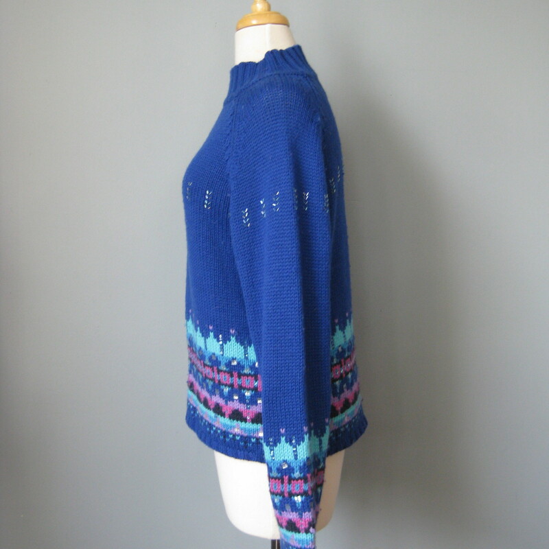 Acrylic and lambswool blend ski sweater by St. John's Bay from the 1980s<br />
So cute in royal blue with touches of lavender and a sprinkling of bugle beads<br />
small section of missing beads as shown<br />
Marked size medium petite<br />
flat measurements:<br />
armpit to armpit: 18.75in<br />
length: 20in<br />
<br />
made in Hong Kong<br />
<br />
thanks for looking!<br />
#39252