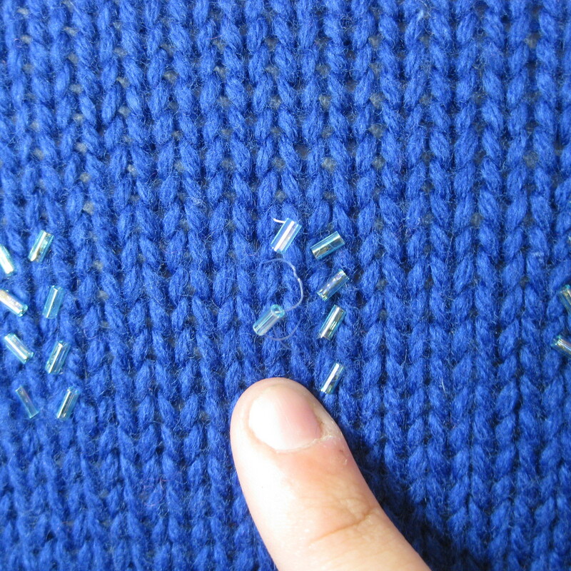 Acrylic and lambswool blend ski sweater by St. John's Bay from the 1980s
So cute in royal blue with touches of lavender and a sprinkling of bugle beads
small section of missing beads as shown
Marked size medium petite
flat measurements:
armpit to armpit: 18.75in
length: 20in

made in Hong Kong

thanks for looking!
#39252